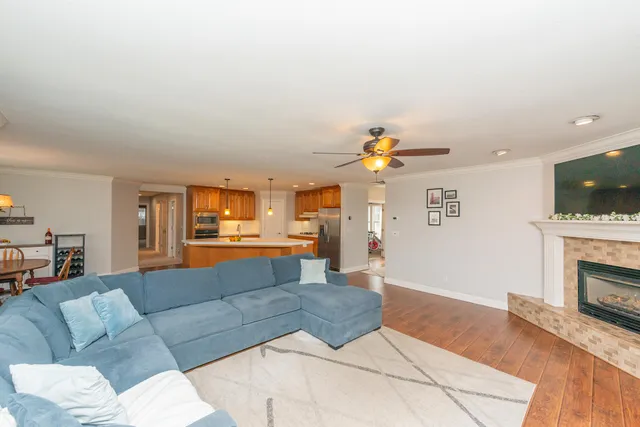 a dining room with furniture a chandelier and wooden floor
