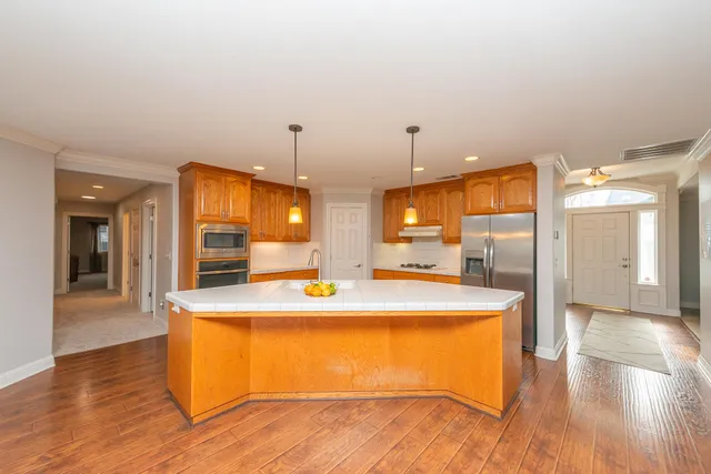a spacious bedroom with a bed and a flat screen tv