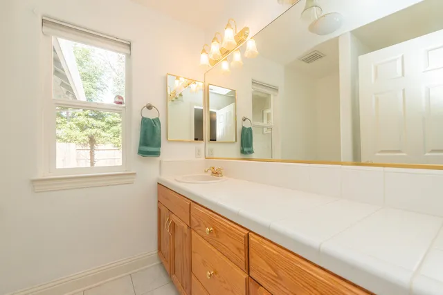 a view of a house with backyard and sitting area