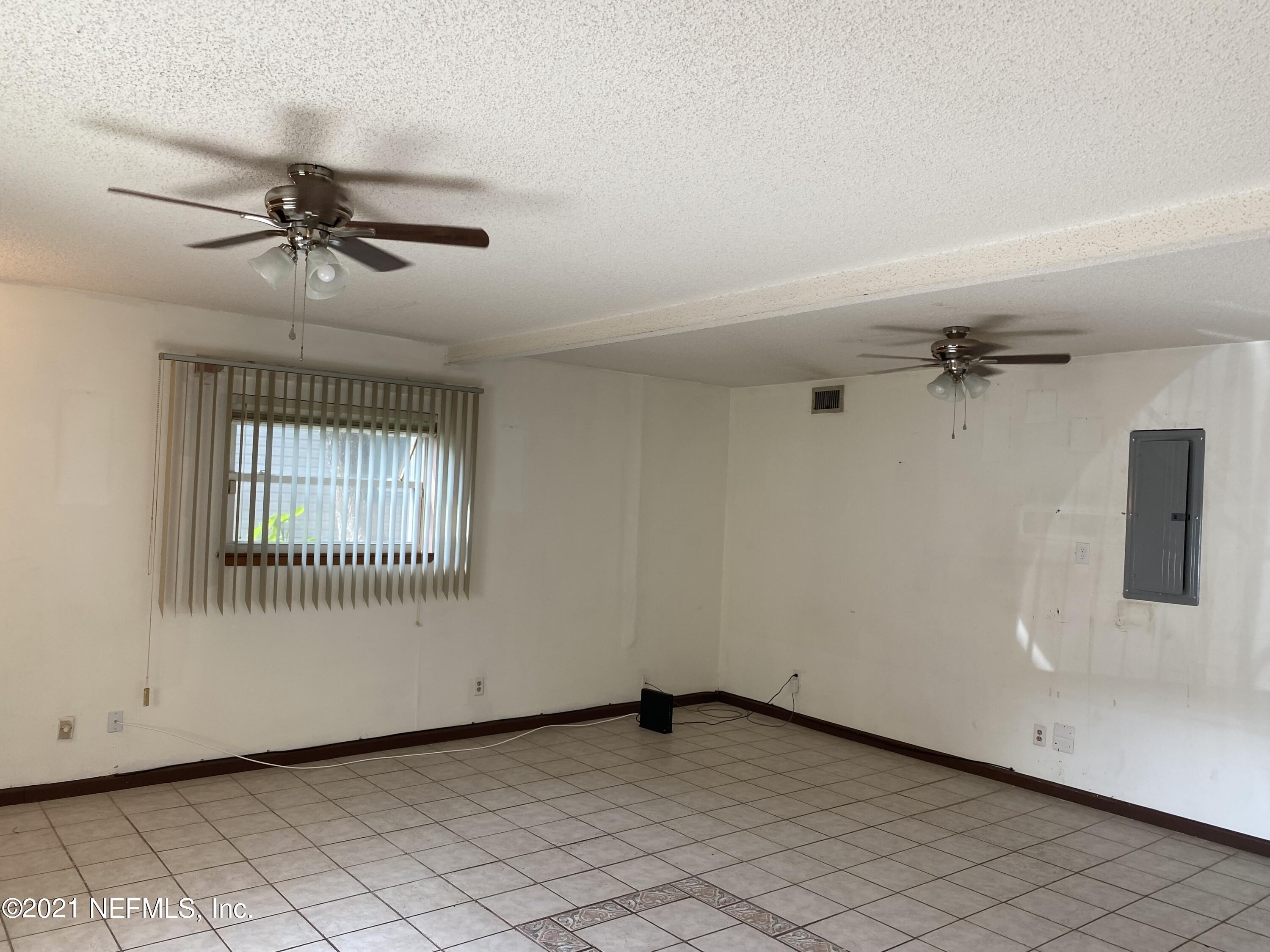 3758 Grant Road Jacksonville, FL 32207 - Photo 3 of 19 an empty room with windows