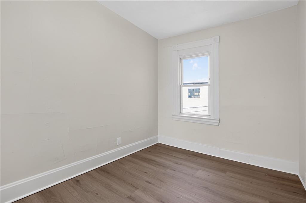 405 Main Street Coraopolis, PA 15108 - Photo 10 of 15 a view of an empty room with wooden floor and a window