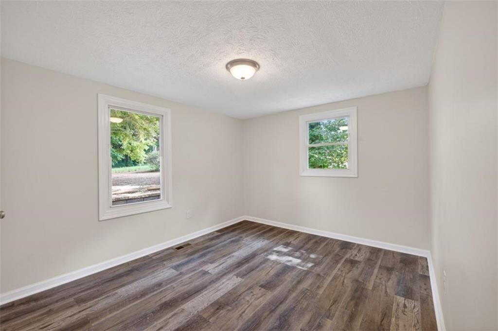 136 Nowell Street Monroe, GA 30655 - Photo 22 of 25 a view of a room that has wooden floor and window