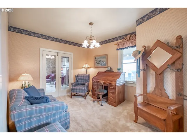 a living room with furniture a chandelier and a piano