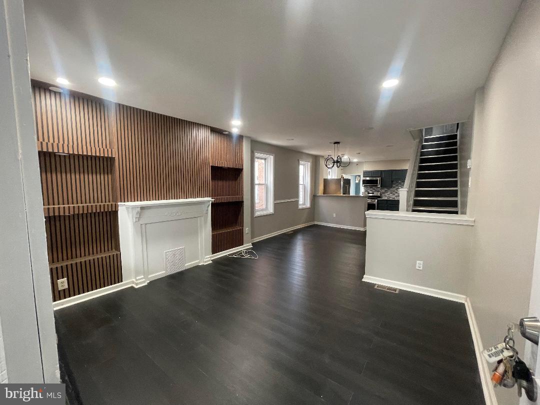 1119 Chestnut Street Darby, PA 19023 - Photo 14 of 37 an empty room with wooden floor and windows