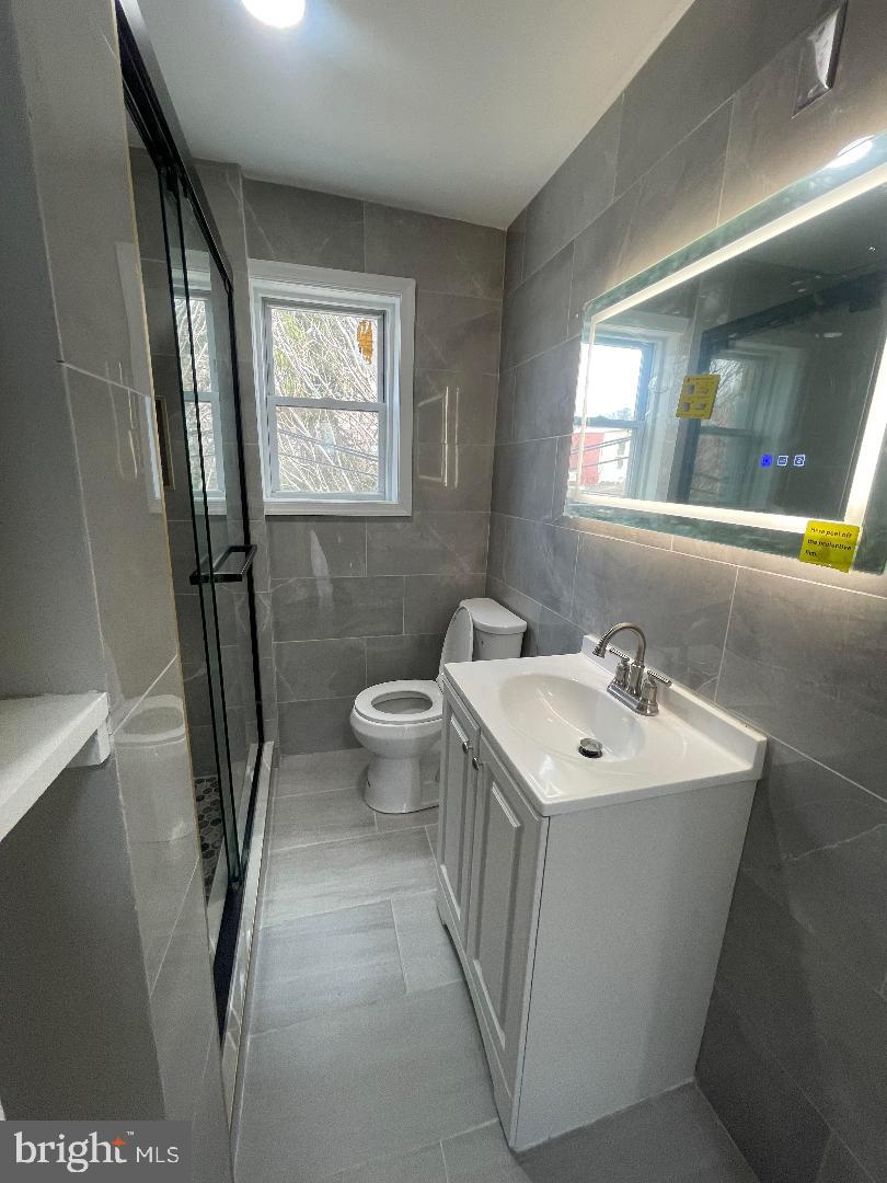 1119 Chestnut Street Darby, PA 19023 - Photo 28 of 37 a bathroom with a sink mirror bathtub and toilet
