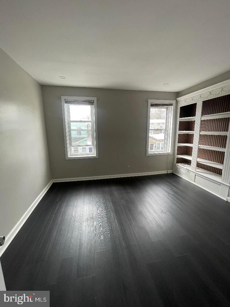 1119 Chestnut Street Darby, PA 19023 - Photo 29 of 37 an empty room with wooden floor and windows