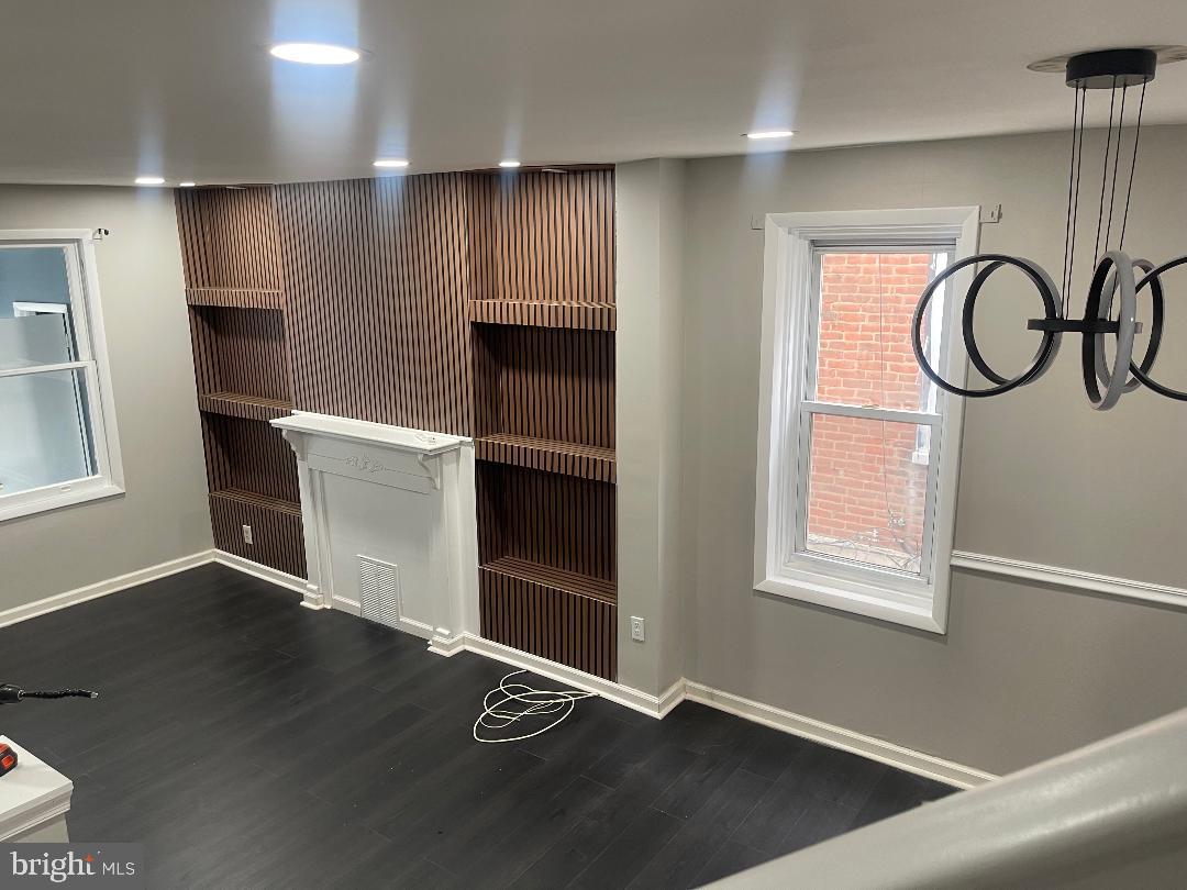 1119 Chestnut Street Darby, PA 19023 - Photo 9 of 37 a view of an empty room with a window and wooden floor