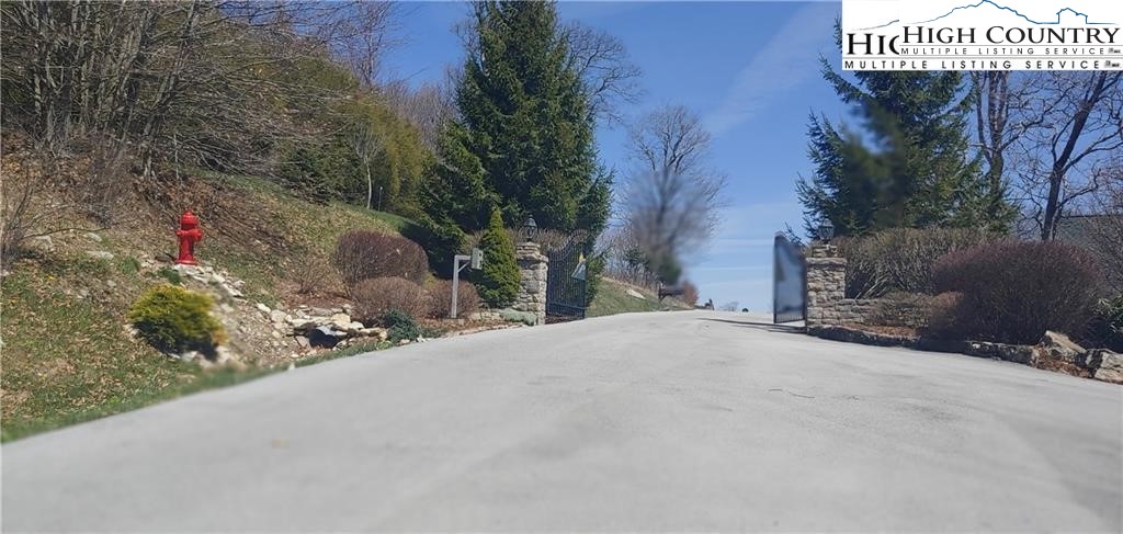 72 Sunset Strip Beech Mountain, NC 28604 - Photo 5 of 18 a pathway of a house with a yard and garage