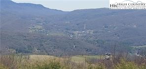 72 Sunset Strip Beech Mountain, NC 28604 - Photo 6 of 18 a view of a dry yard with trees in front of it