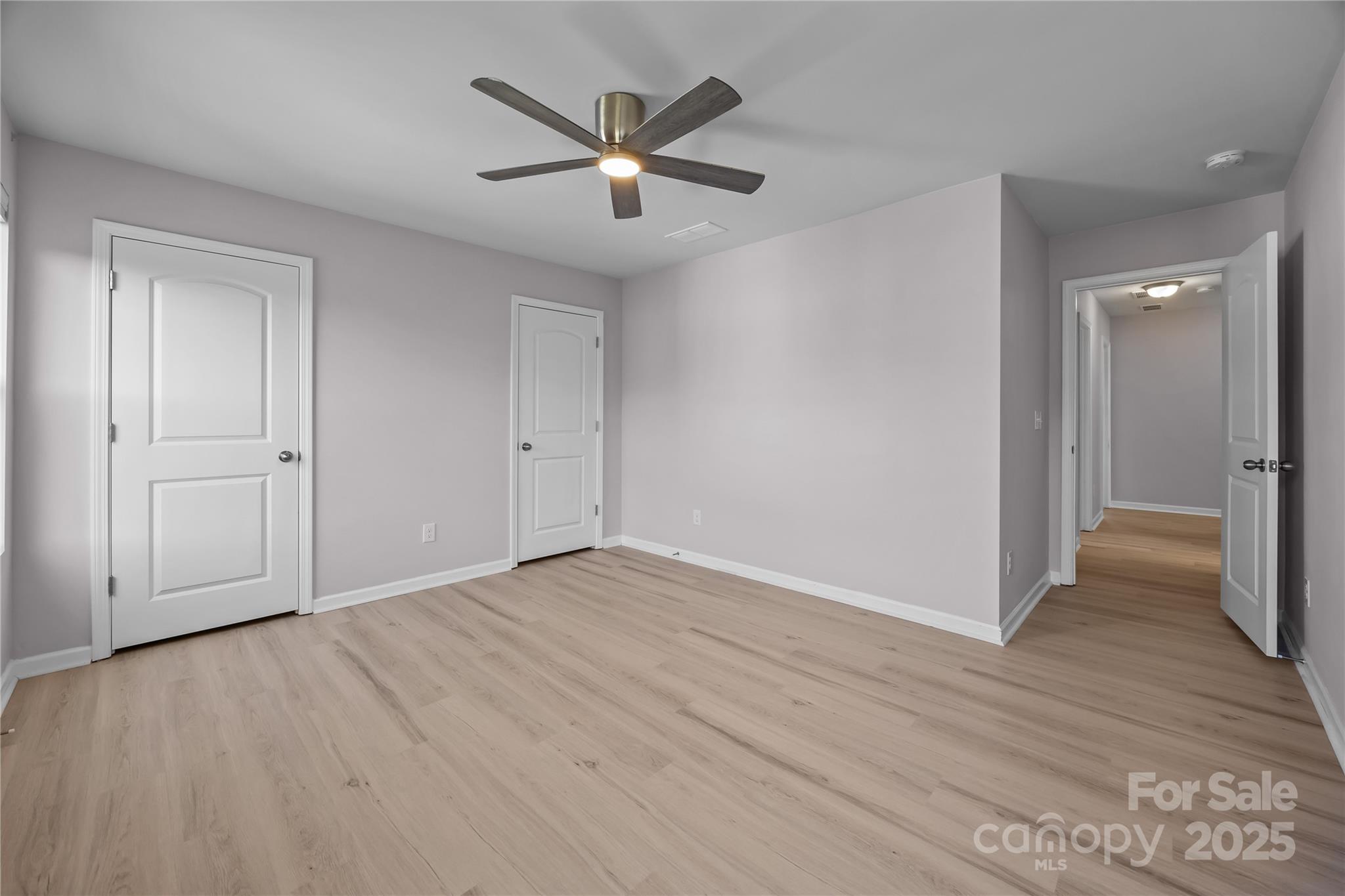 16124 Fieldstone Trace Charlotte, NC 28278 - Photo 25 of 45 an empty room with wooden floor and windows