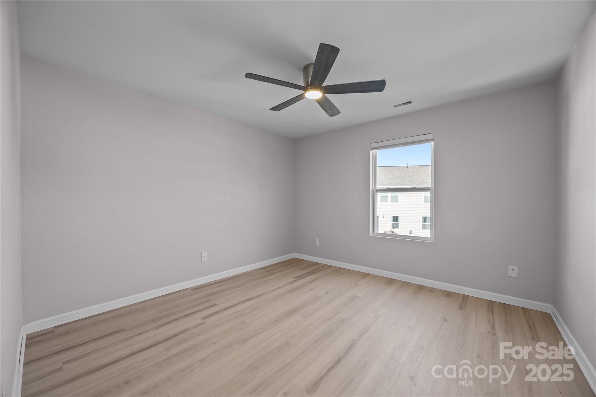16124 Fieldstone Trace Charlotte, NC 28278 - Photo 27 of 45 an empty room with a window and a ceiling fan