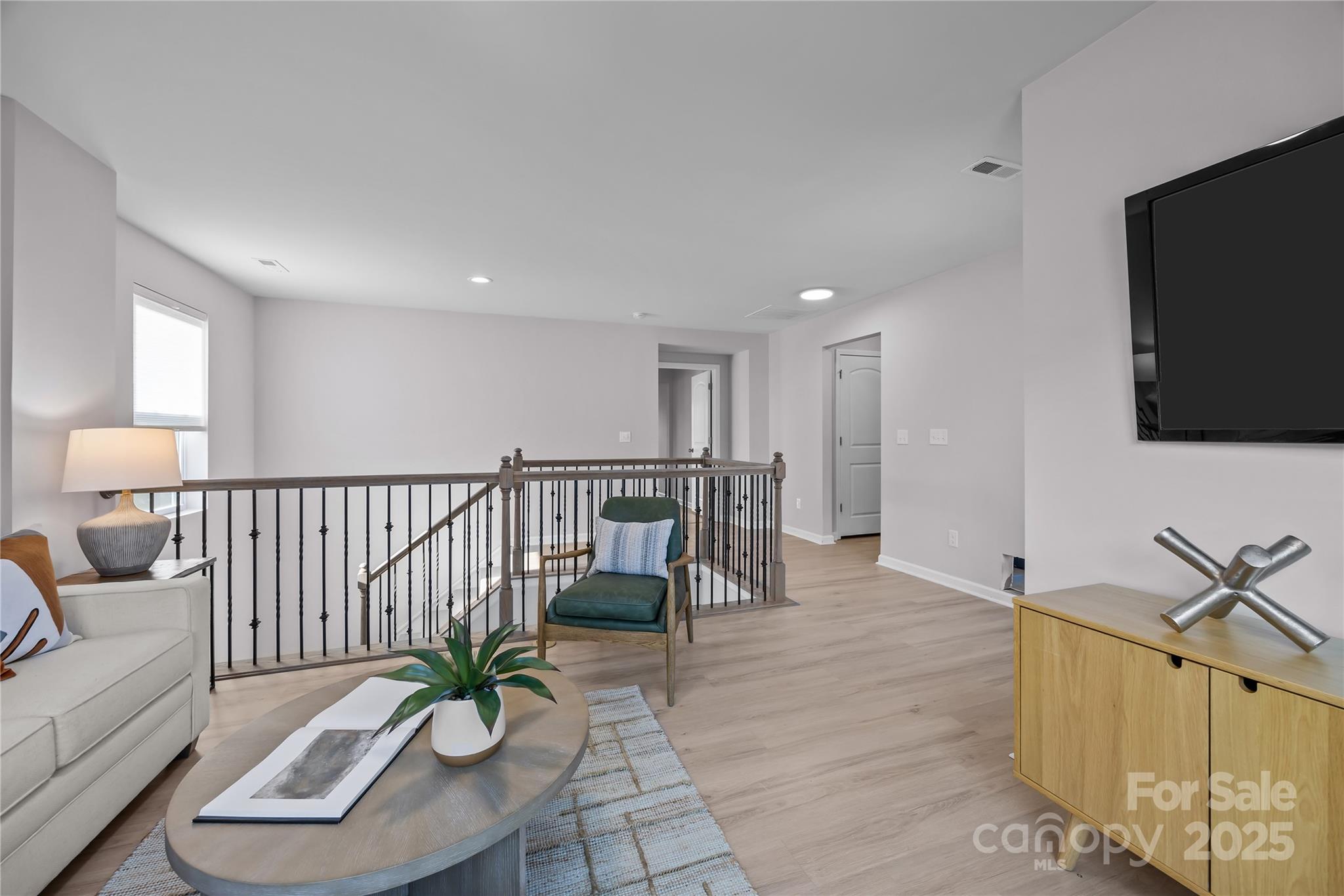 16124 Fieldstone Trace Charlotte, NC 28278 - Photo 32 of 45 a view of a livingroom with furniture and a flat screen tv