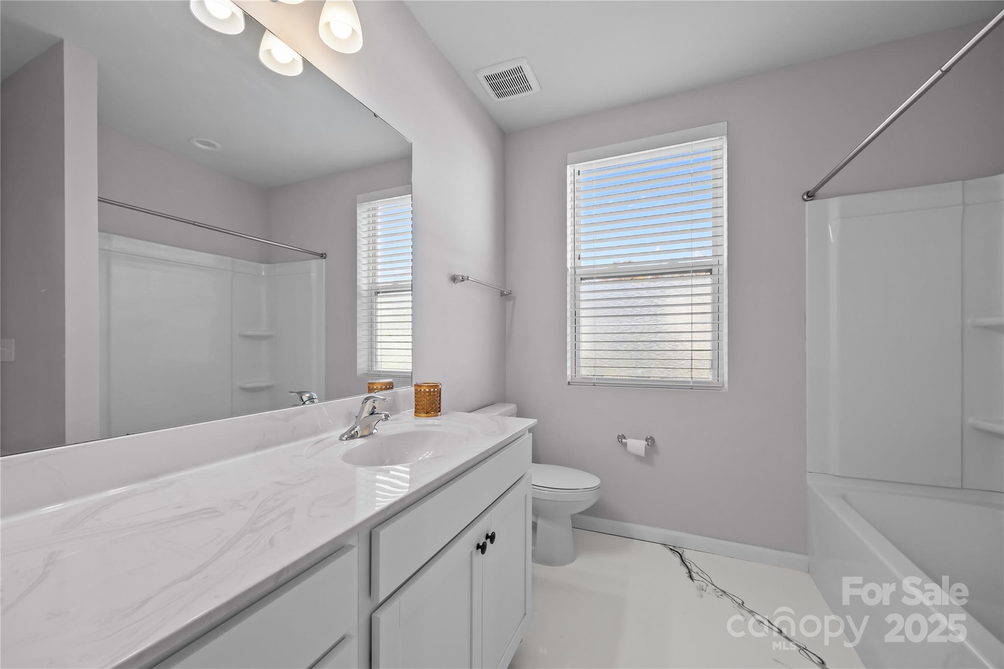 16124 Fieldstone Trace Charlotte, NC 28278 - Photo 37 of 45 a bathroom with a granite countertop sink a toilet and a mirror