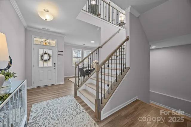 a kitchen with stainless steel appliances granite countertop a sink refrigerator and cabinets