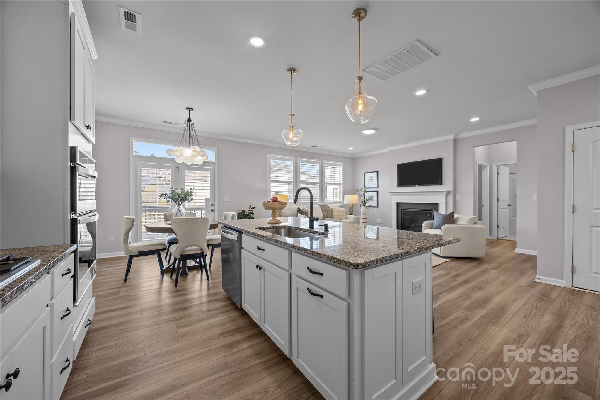 16124 Fieldstone Trace Charlotte, NC 28278 - Photo 8 of 45 a large kitchen with lots of counter space a sink appliances and living room view