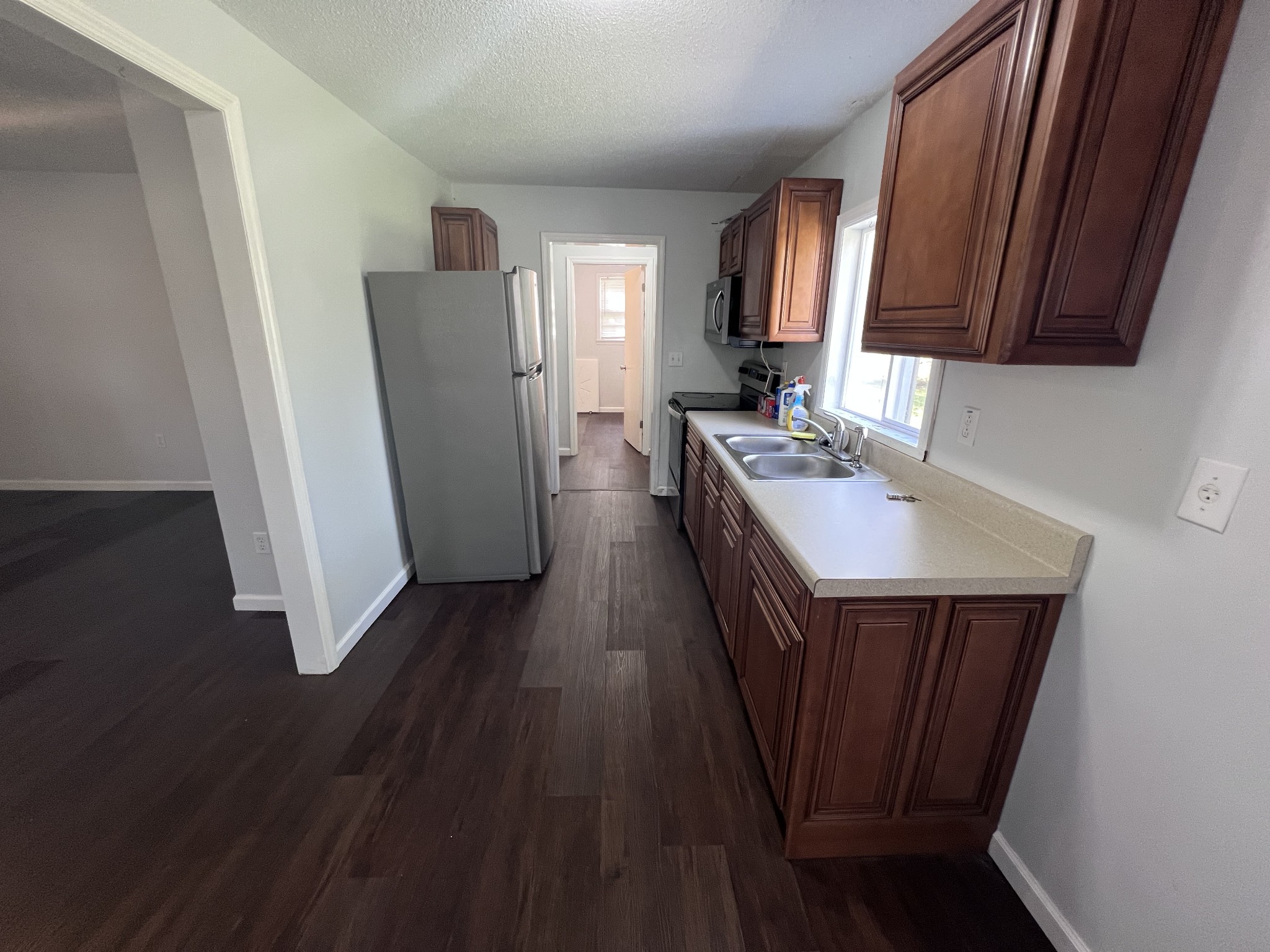 962 3rd Street Tracy City, TN 37387 - Photo 13 of 35 a kitchen with sink a refrigerator and wooden floor