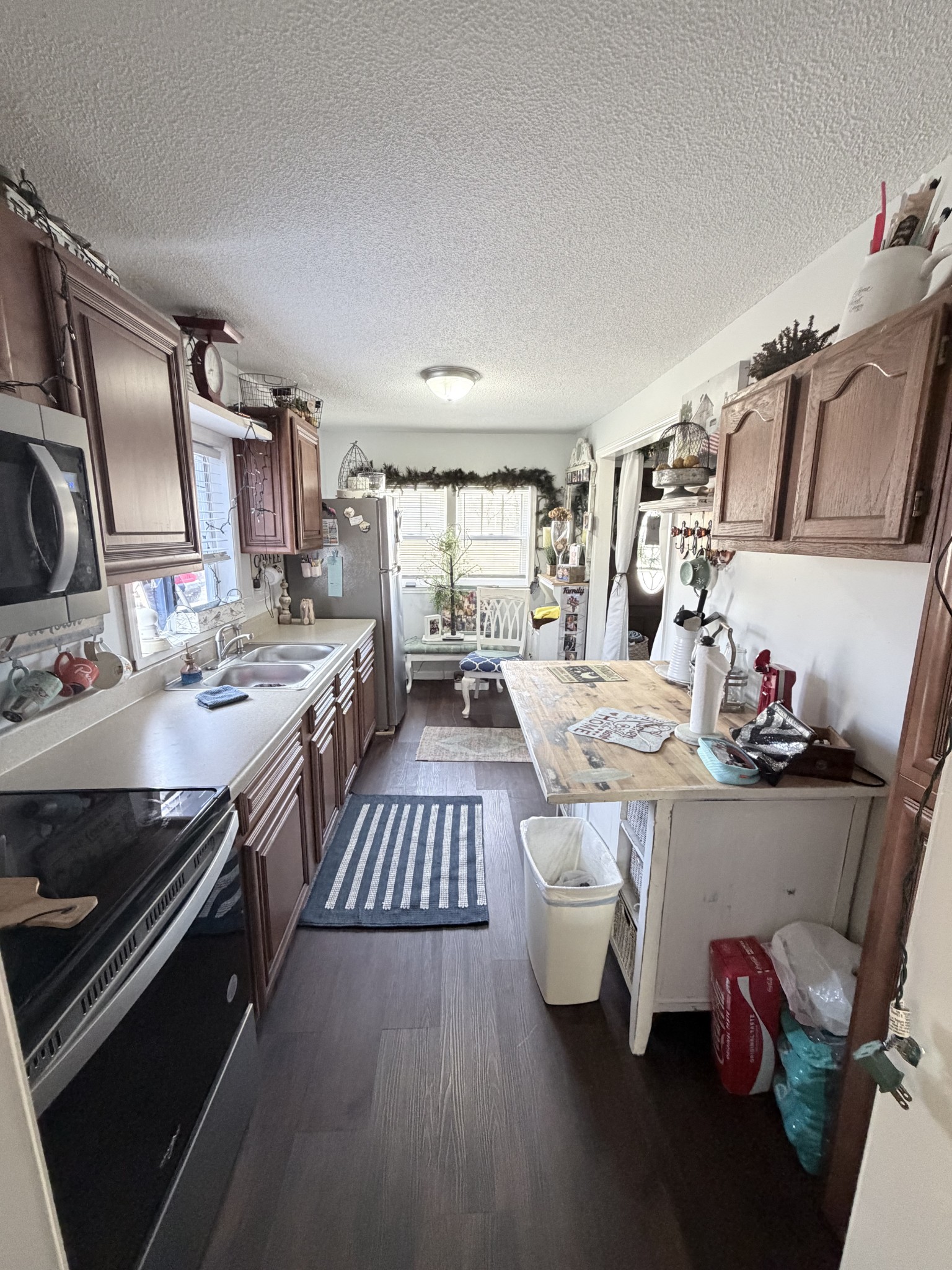 962 3rd Street Tracy City, TN 37387 - Photo 25 of 35 a kitchen with stainless steel appliances a stove a sink dishwasher and cabinets with wooden floor