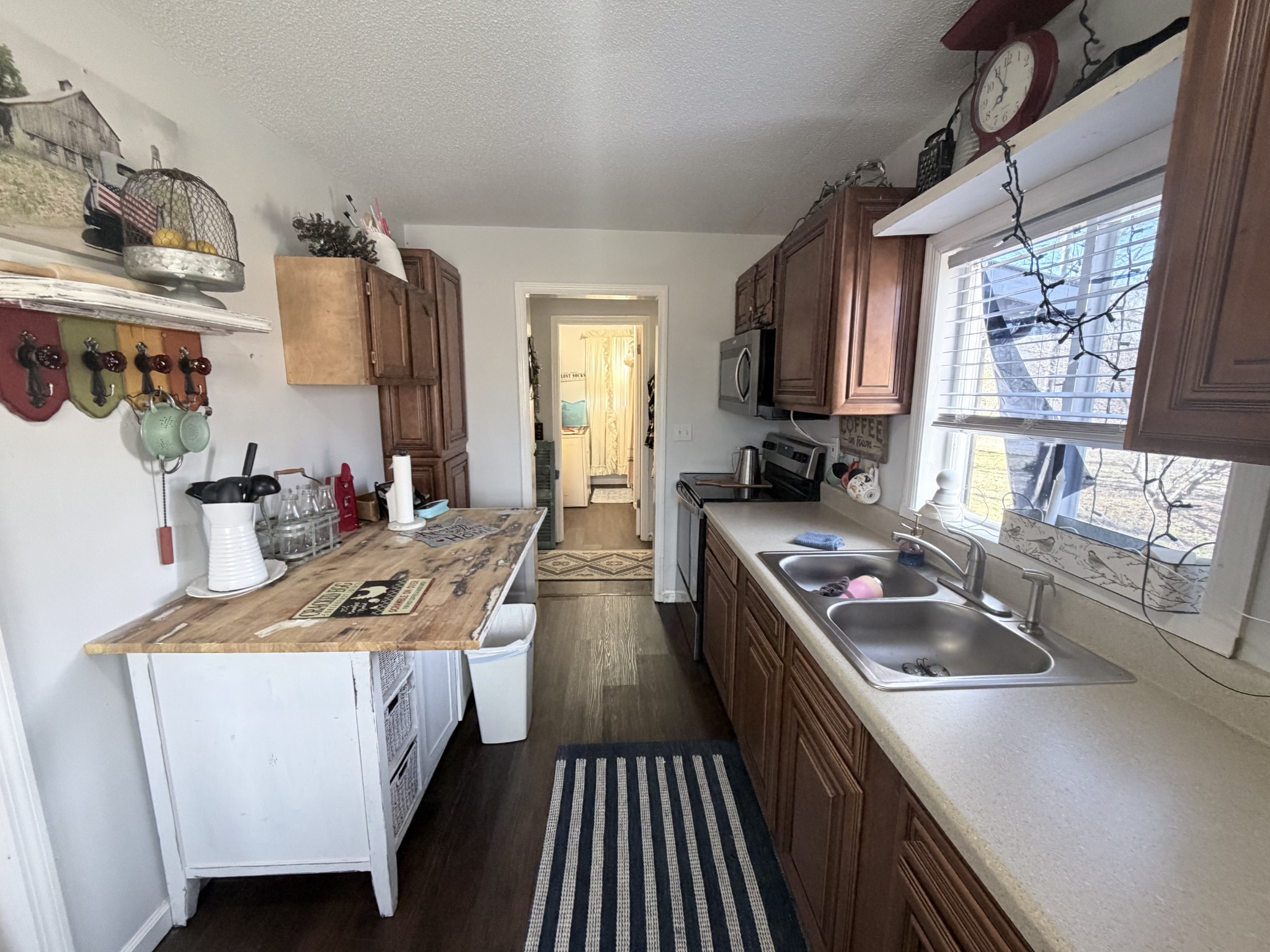 962 3rd Street Tracy City, TN 37387 - Photo 31 of 35 a kitchen with stainless steel appliances granite countertop a stove a sink dishwasher and cabinets with wooden floor