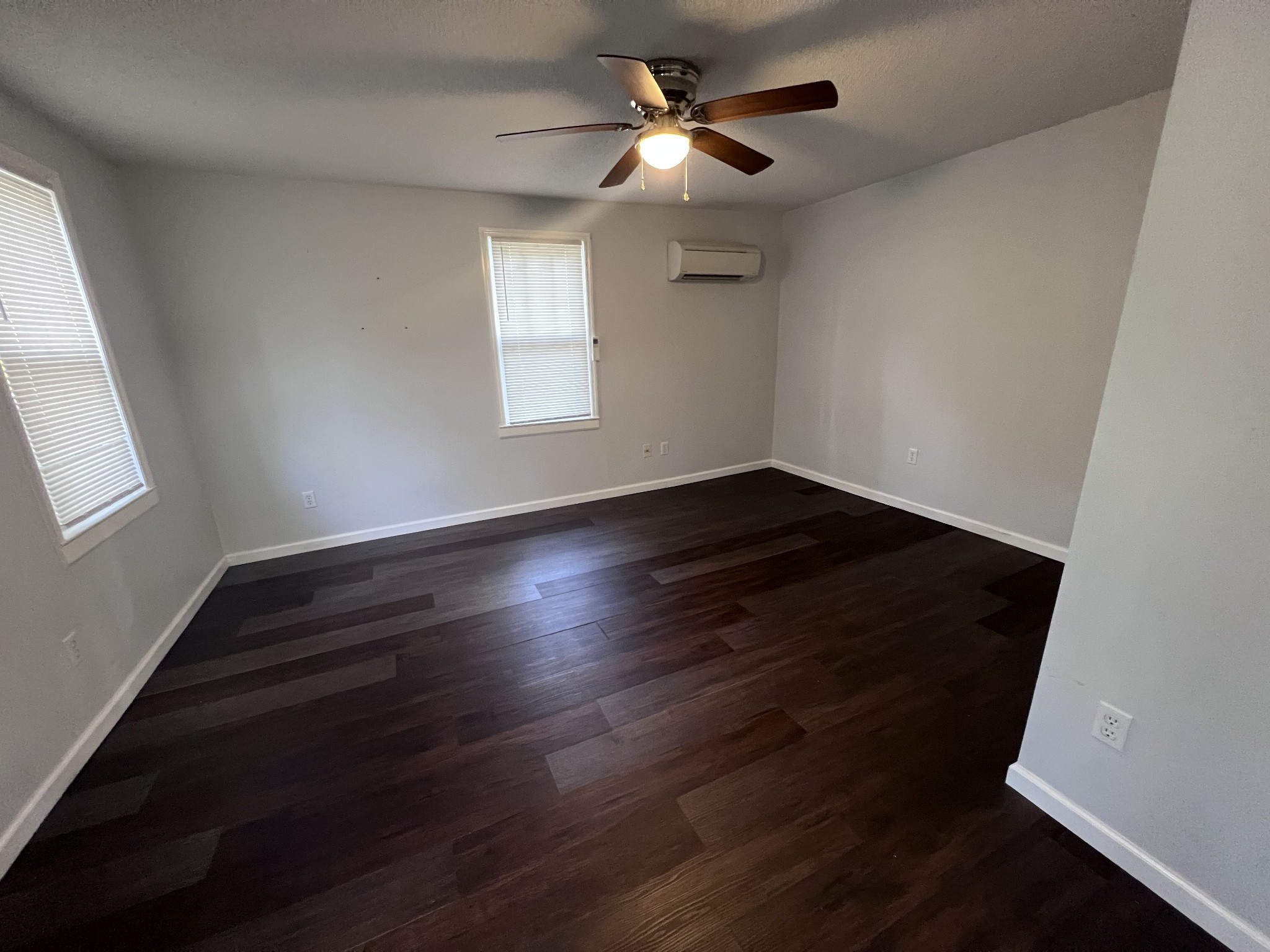 962 3rd Street Tracy City, TN 37387 - Photo 10 of 35 an empty room with wooden floor fan and windows