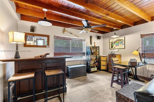 a kitchen with cabinets and chairs