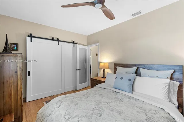 a large bed in a bedroom next to a bathroom