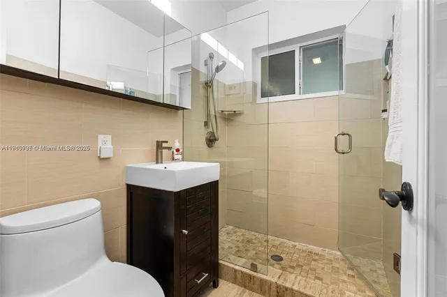 a bathroom with a sink toilet and shower