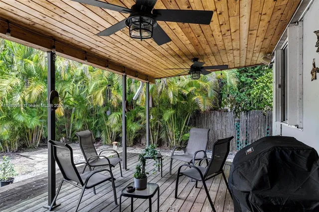 a view of patio with table and chairs and potted plants