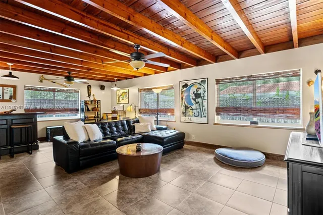 a living room with furniture a large window