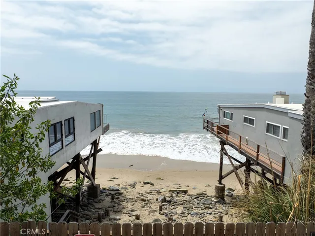 a view of a terrace with wooden floor and ocean view