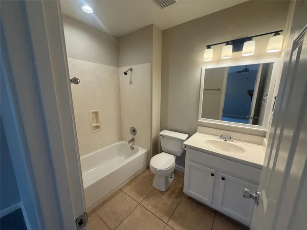 an empty room with windows and cabinet