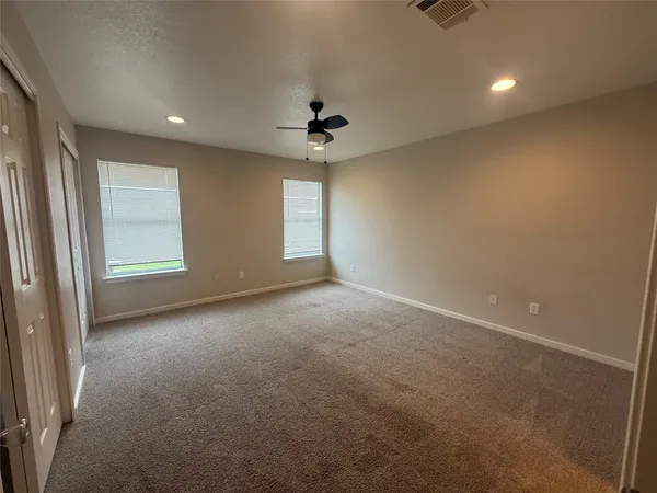 an empty room with windows and entrance