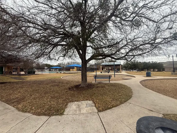 a bathroom with a bathtub shower sink vanity mirror and toilet