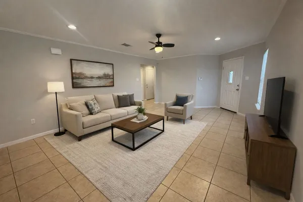 a living room with furniture and a flat screen tv