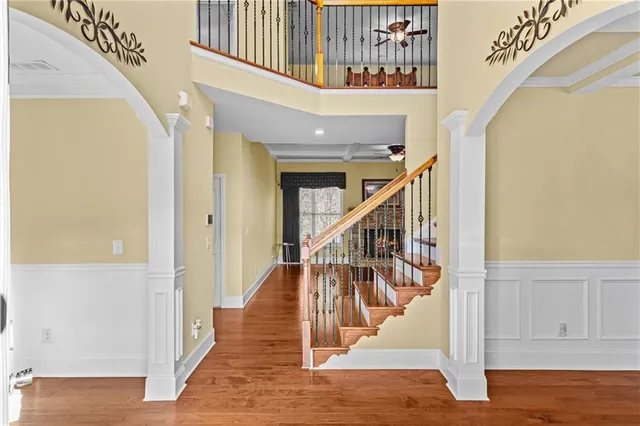 a view of entryway and hall with wooden floor