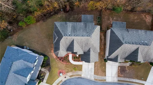 an aerial view of a house with a yard