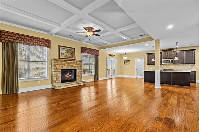 a view of a kitchen with a sink and wooden floor