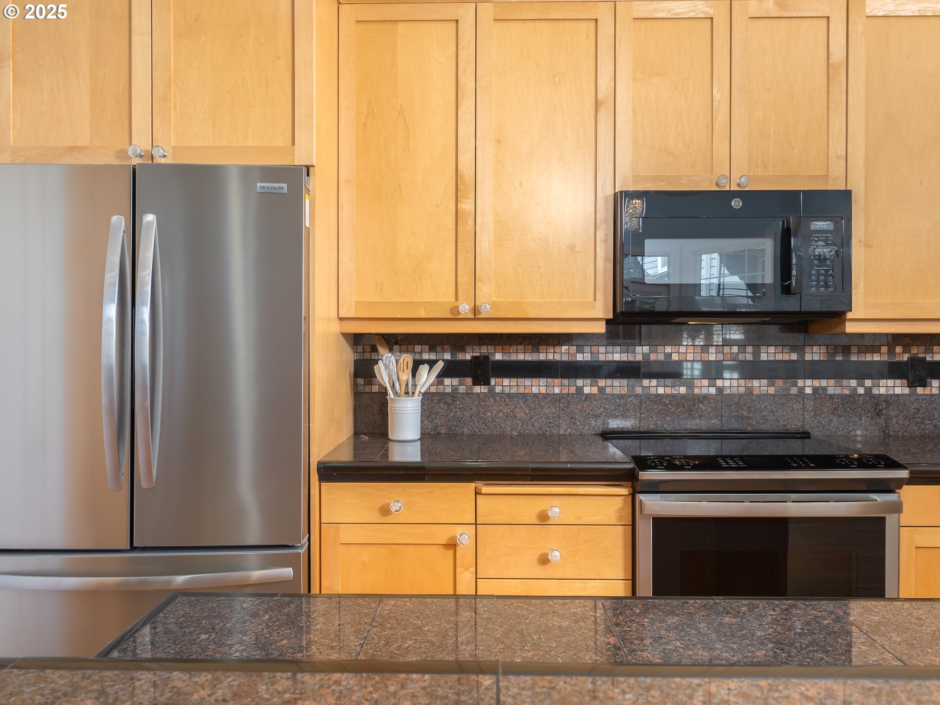 3866 Oak Meadows Loop Newberg, OR 97132 - Photo 21 of 48 a kitchen with stainless steel appliances granite countertop a refrigerator and a stove