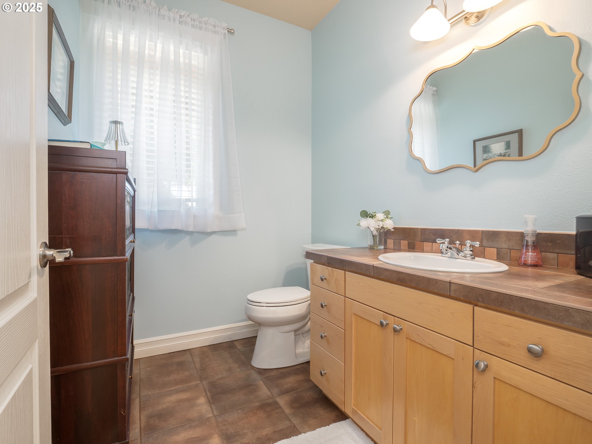 3866 Oak Meadows Loop Newberg, OR 97132 - Photo 28 of 48 a bathroom with a granite countertop sink toilet and mirror