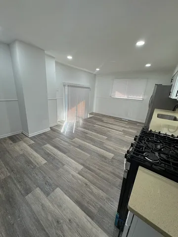 a view of a room with wooden floor