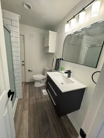 a bathroom with a sink mirror and toilet