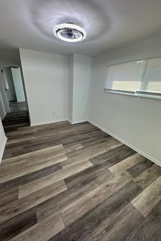 a view of a room with a wooden floor