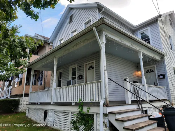 a view of a house with wooden walls and stairs