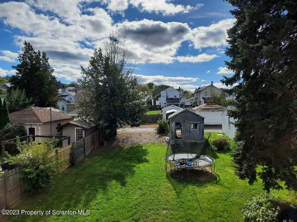 an aerial view of a house with garden space and street view
