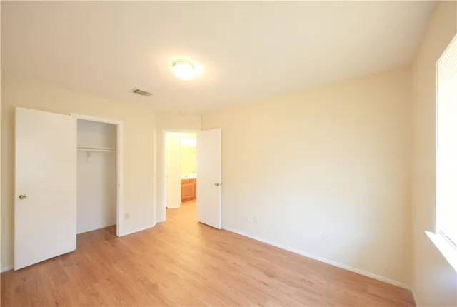 a view of a room with wooden floor