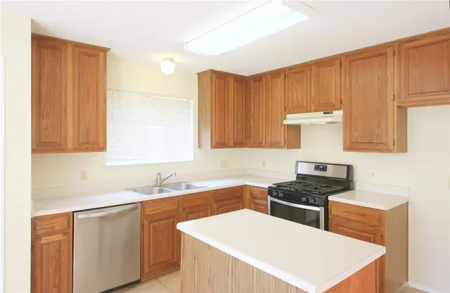 a kitchen that has a sink and a stove in it