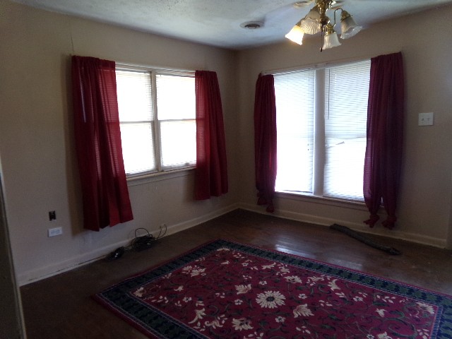 12 Knight Street Erin, TN 37061 - Photo 2 of 7 wooden floor in an empty room with a window