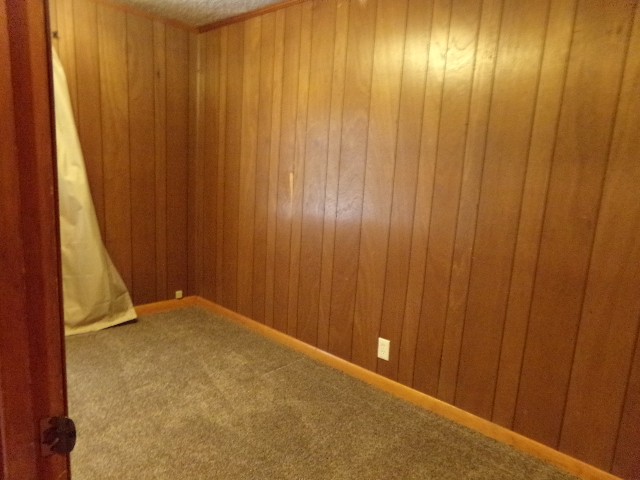 12 Knight Street Erin, TN 37061 - Photo 4 of 7 a view of an empty room with wooden walls