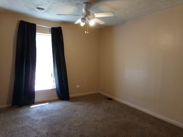 12 Knight Street Erin, TN 37061 - Photo 5 of 7 an empty room with windows and fan