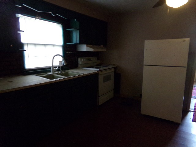 12 Knight Street Erin, TN 37061 - Photo 6 of 7 a kitchen with a sink a refrigerator and window