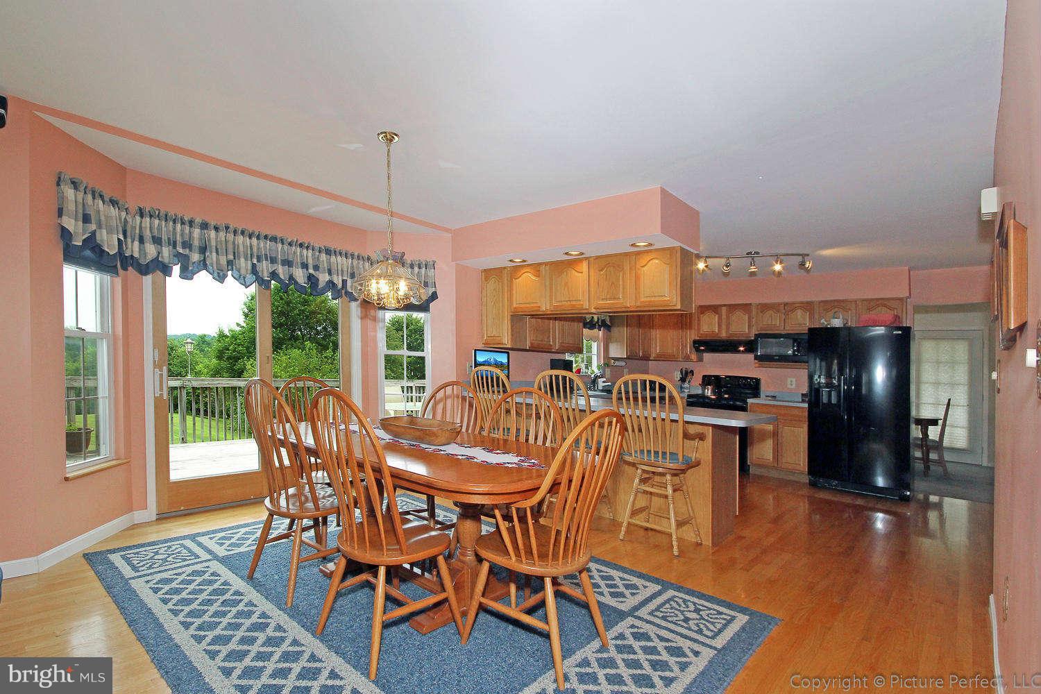 13132 Jesse Smith Road Mount Airy, MD 21771 - Photo 13 of 30 a dining room with furniture a chandelier and wooden floor